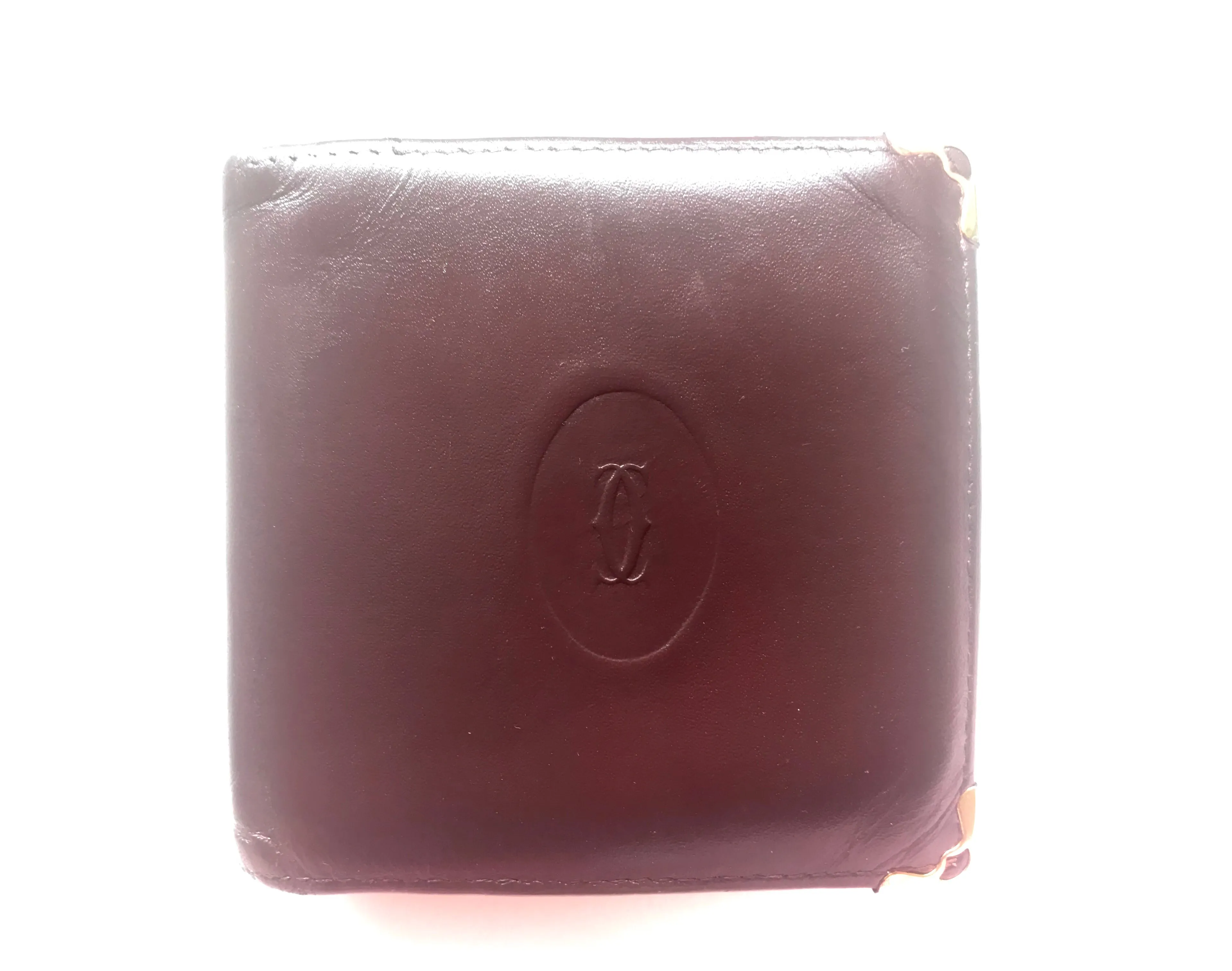 Vintage Cartier, must de Cartier wine leather square wallet with gold tone frames. Unisex use.